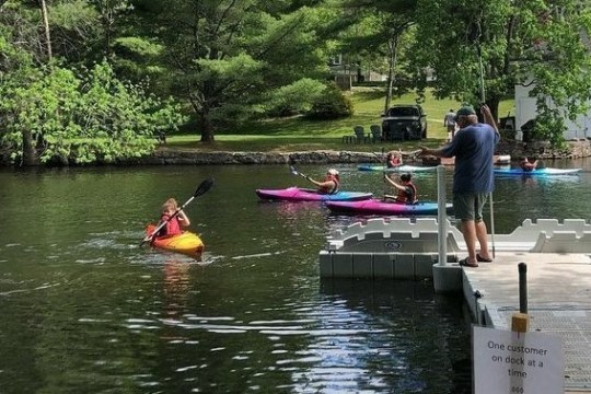 a group of people rowing a boat in the water